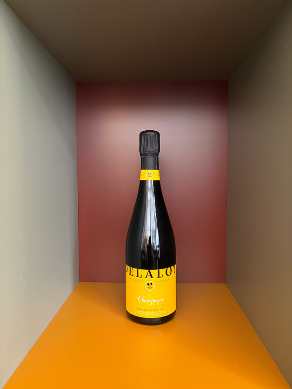 Éliane Delalot Champagne bottle with yellow label and black foil
