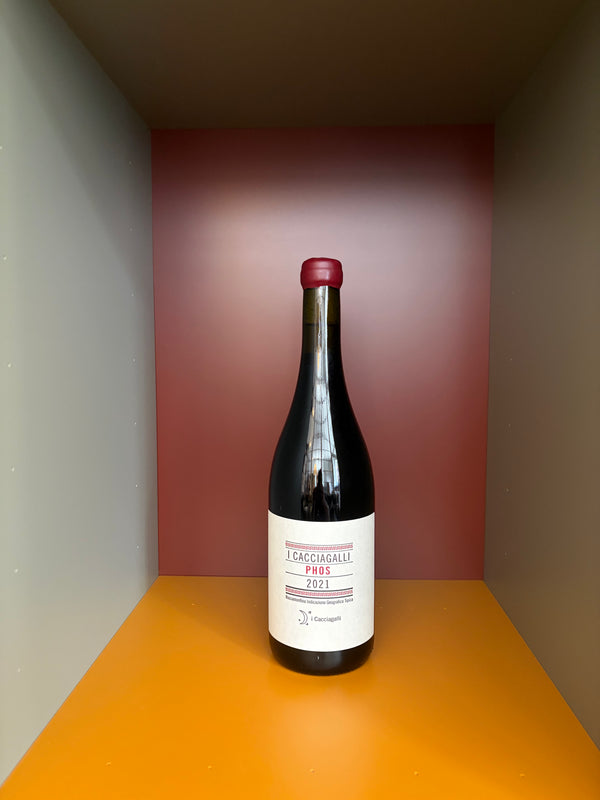 Wine bottle with red cap and white label, dark glass