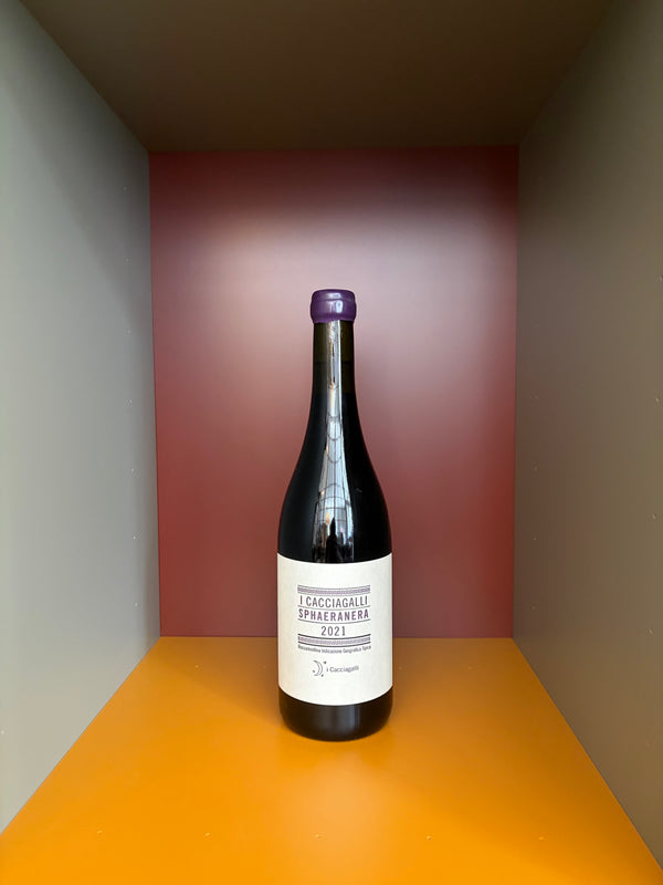 Dark glass wine bottle with white label and purple cap