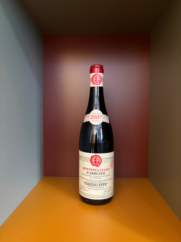 Emidio Pepe Montepulciano d’Abruzzo wine bottle, red cap, dark glass, label front