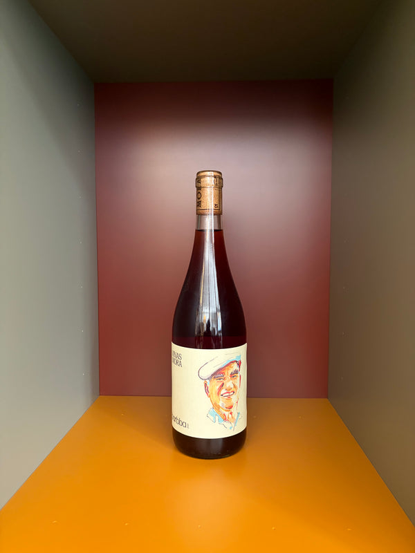 Wine bottle with foil capsule and illustrated front label, cork sealed