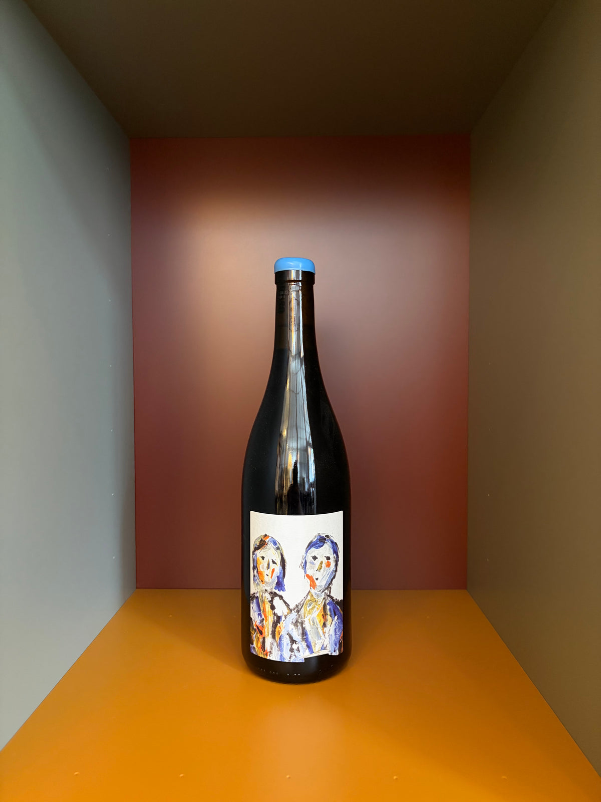 Naboso Spolu wine bottle with blue foil cap and colorful face label.