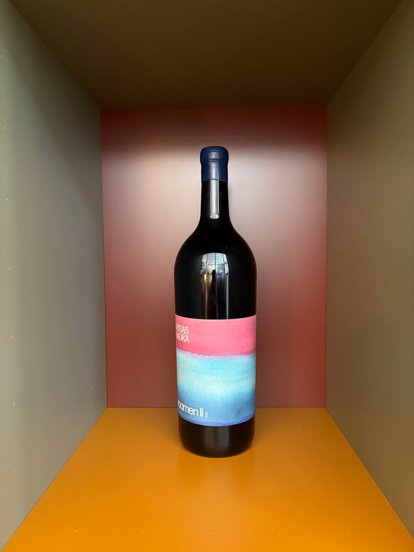 Magnum wine bottle with dark glass and pink-and-blue label